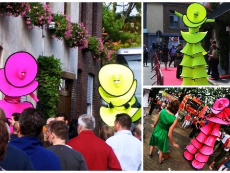 Cirque Colour Steltenlopers: Elegante figuren in roze en geel voor betoverend entertainment op uw event! Flexibele speeltijd en LED-optie beschikbaar.